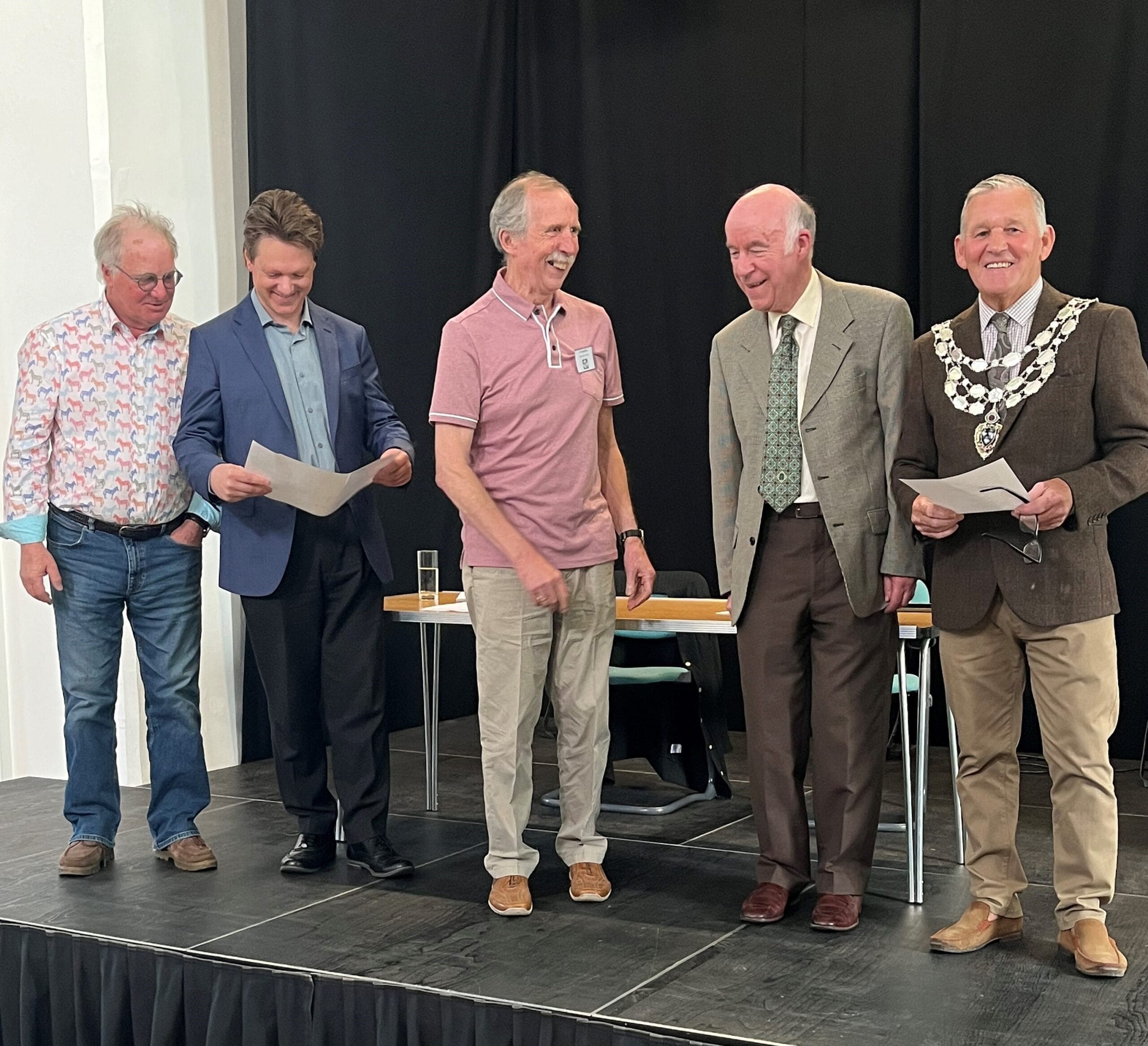 This photo shows members of the Selby Civic Society receiving their grant from the Mayor. They are laughing and smiling.
