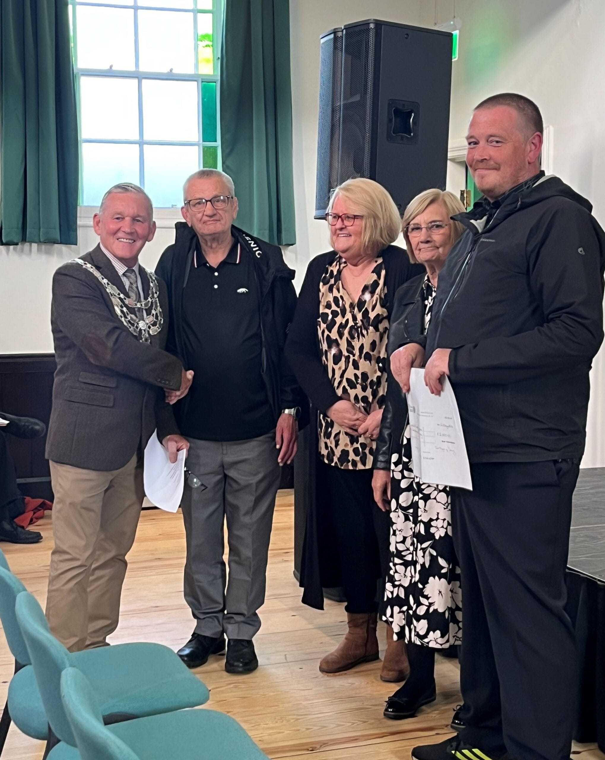 This photo shows members of the Community Centre receiving their grant from the Mayor