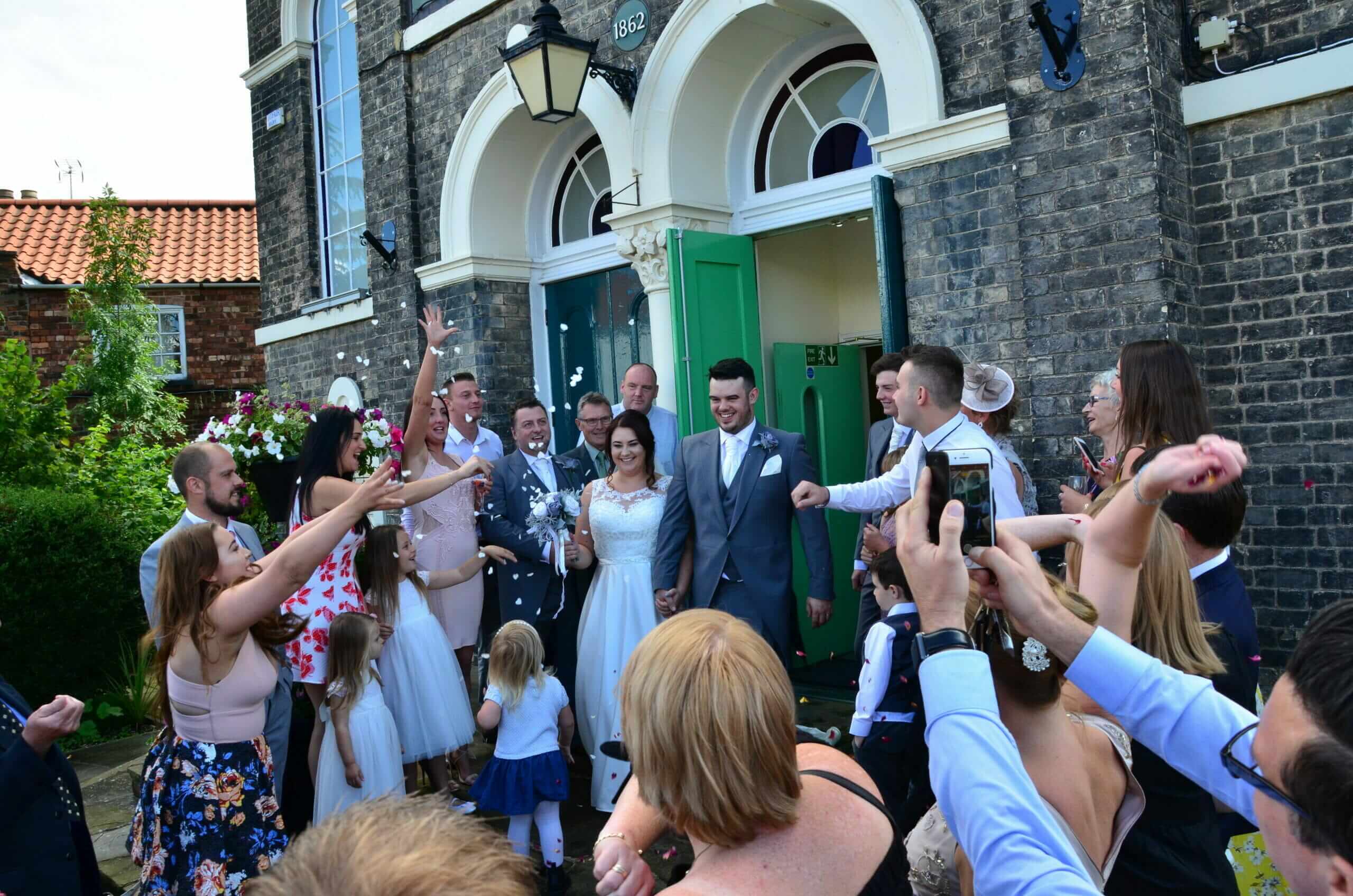 Photo shows a wedding couple on the front steps of the Town Hall