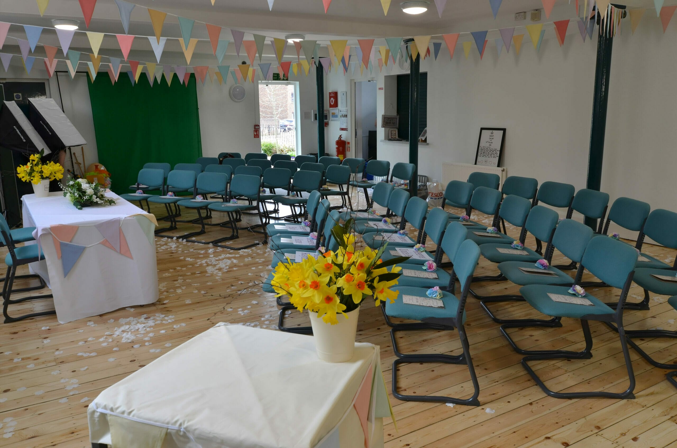 Photo shows a room layout with chairs and bunting