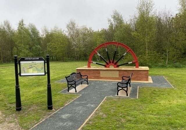 A photo showing the completed mining wheel memorial