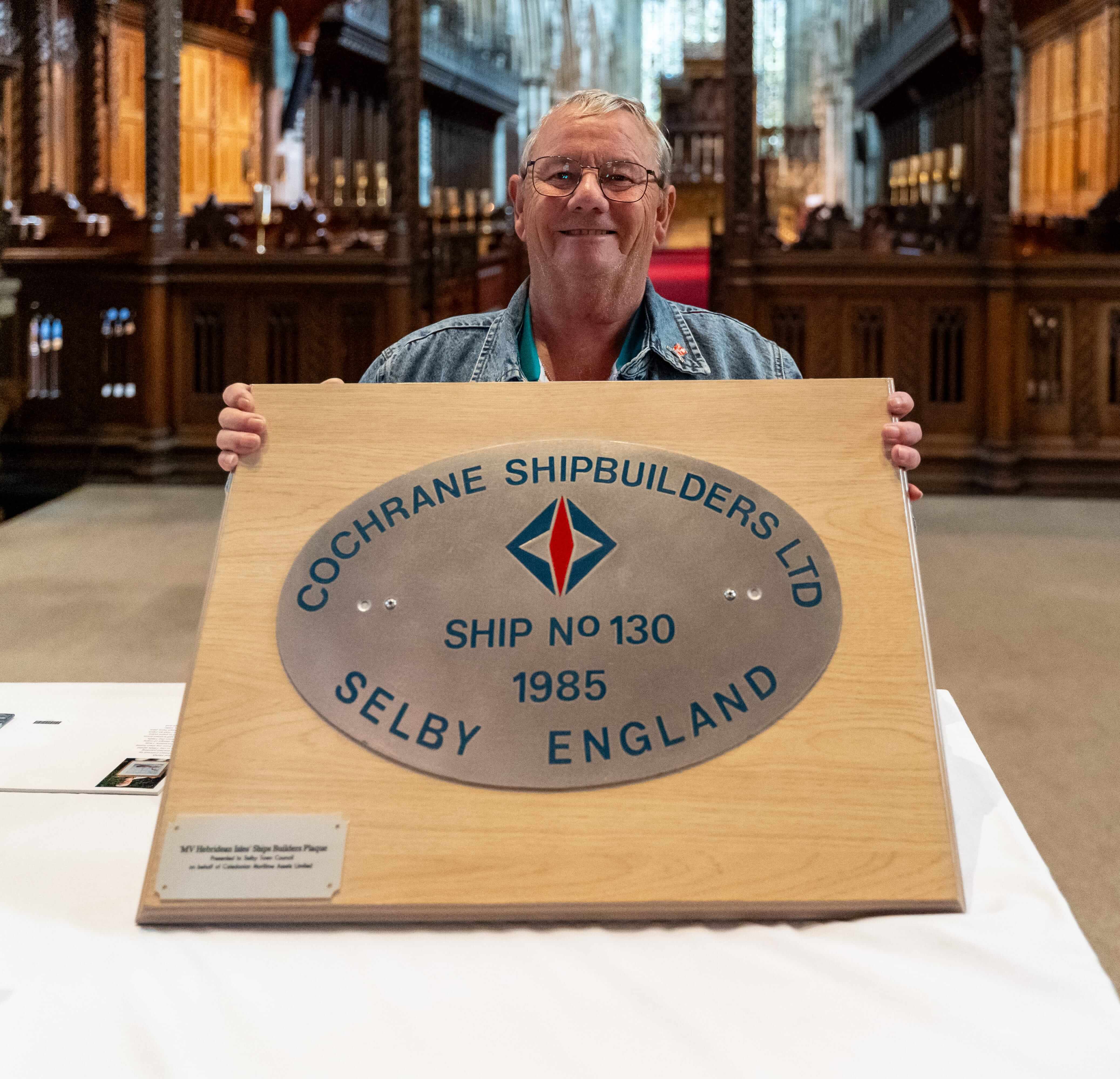 Photo of a man holding the plaque
