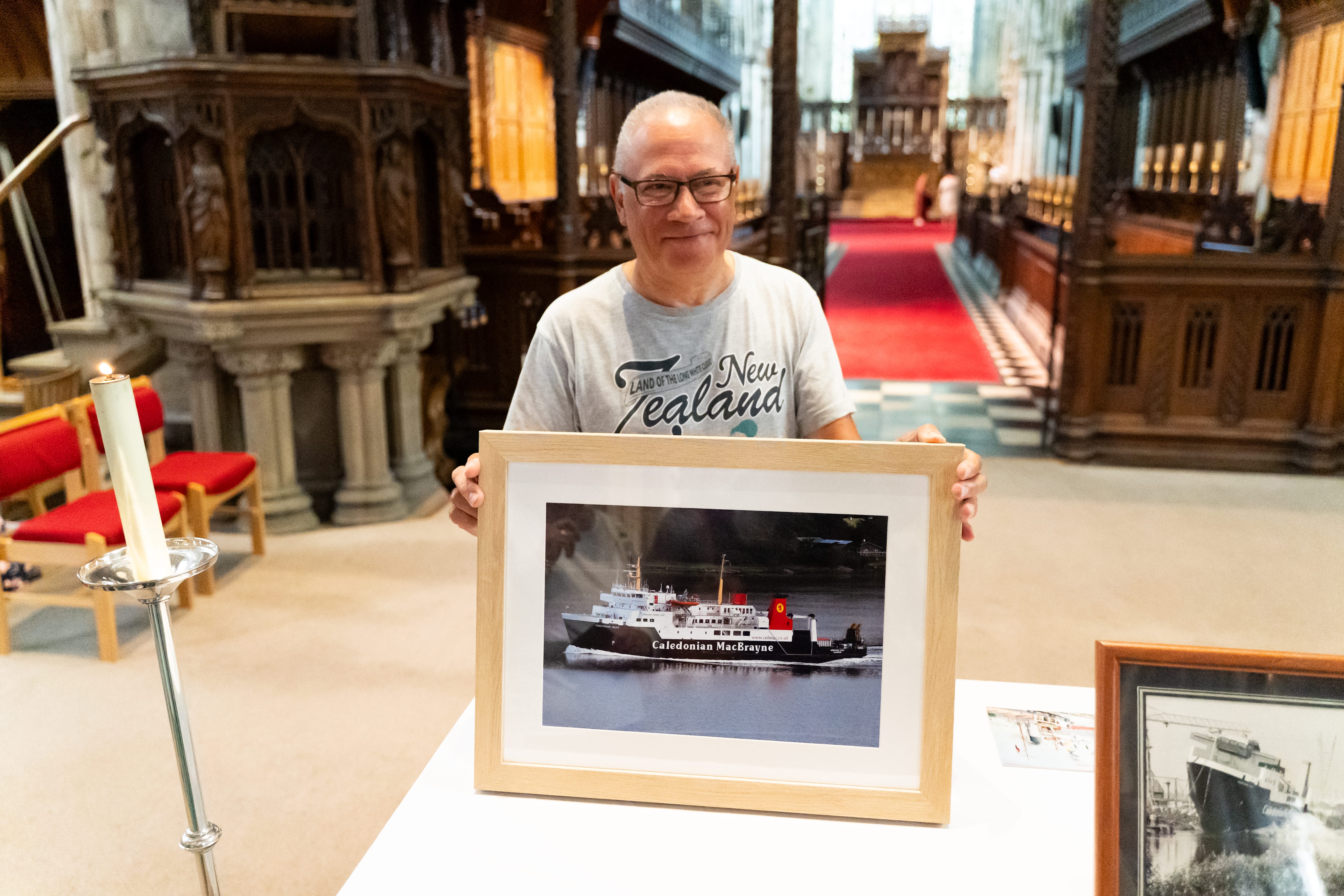 Photo of a man holding a photo of the Hebridean Isles