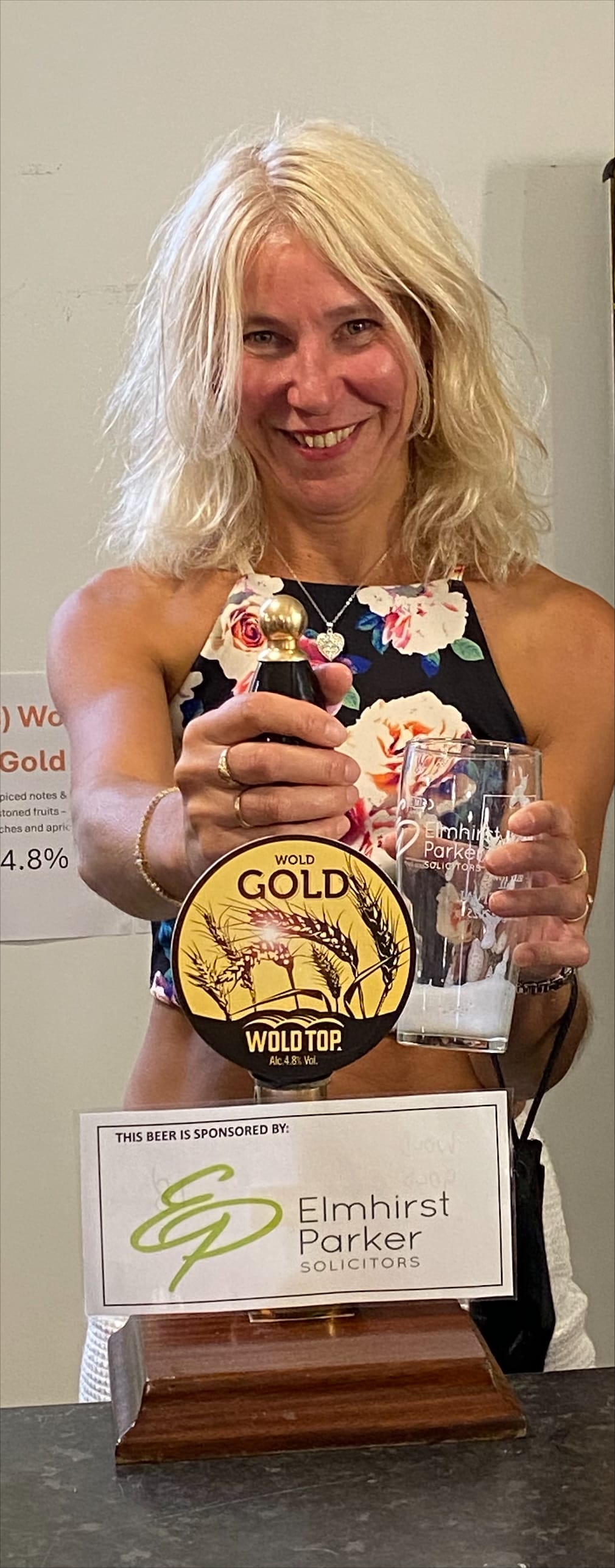 Photo of a lady pulling a pint