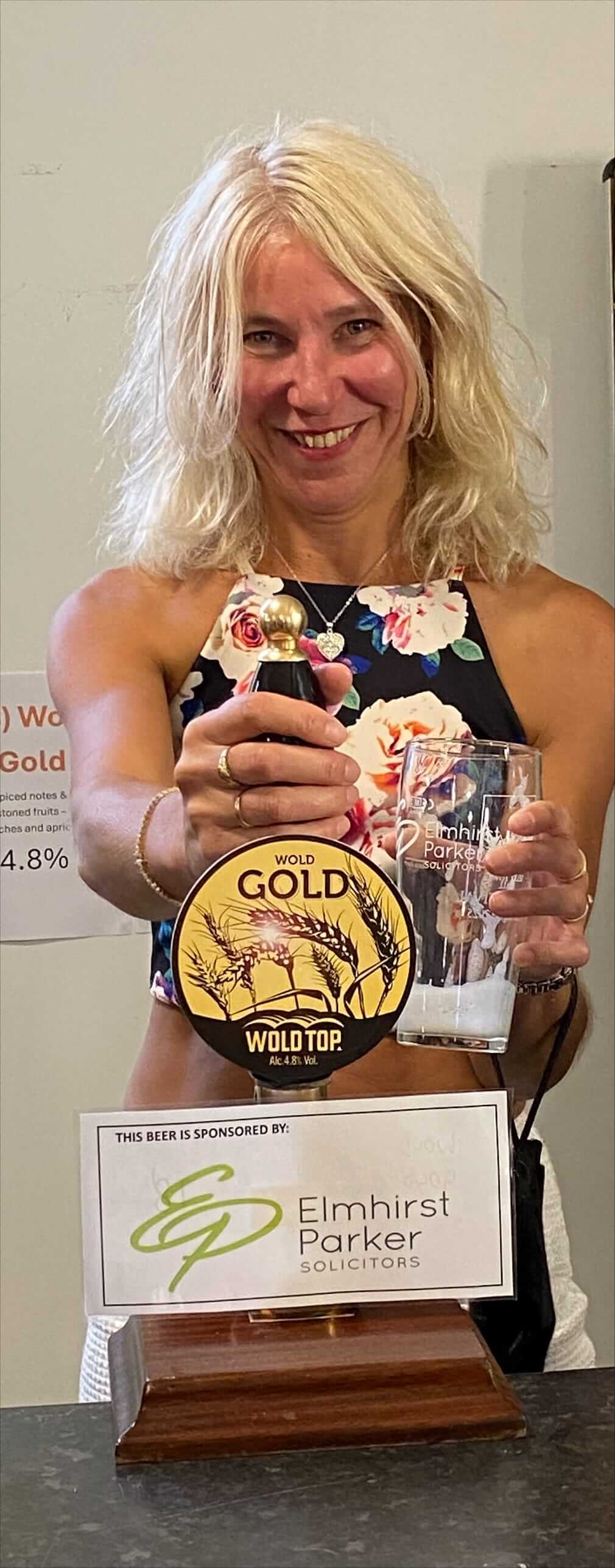 Photo of a lady pulling a pint